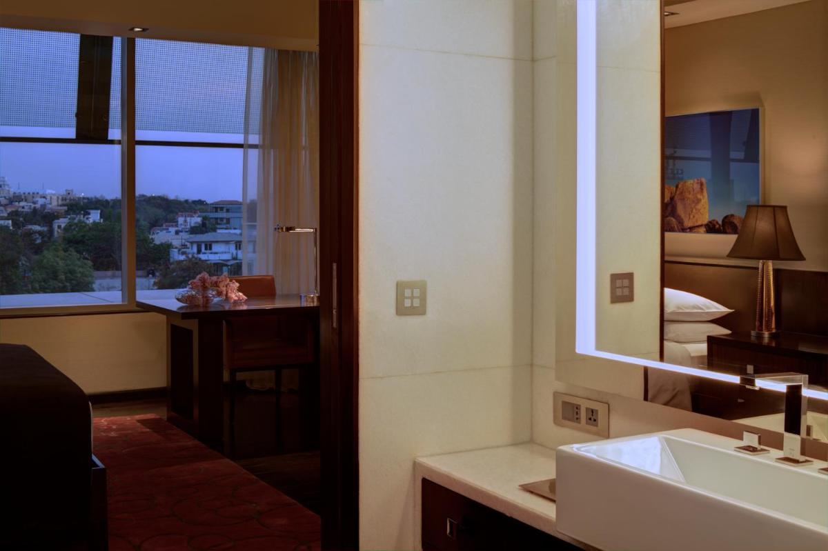 a bathroom with a sink and a mirror at Park Hyatt Hotel and Residences, Hyderabad in Hyderabad