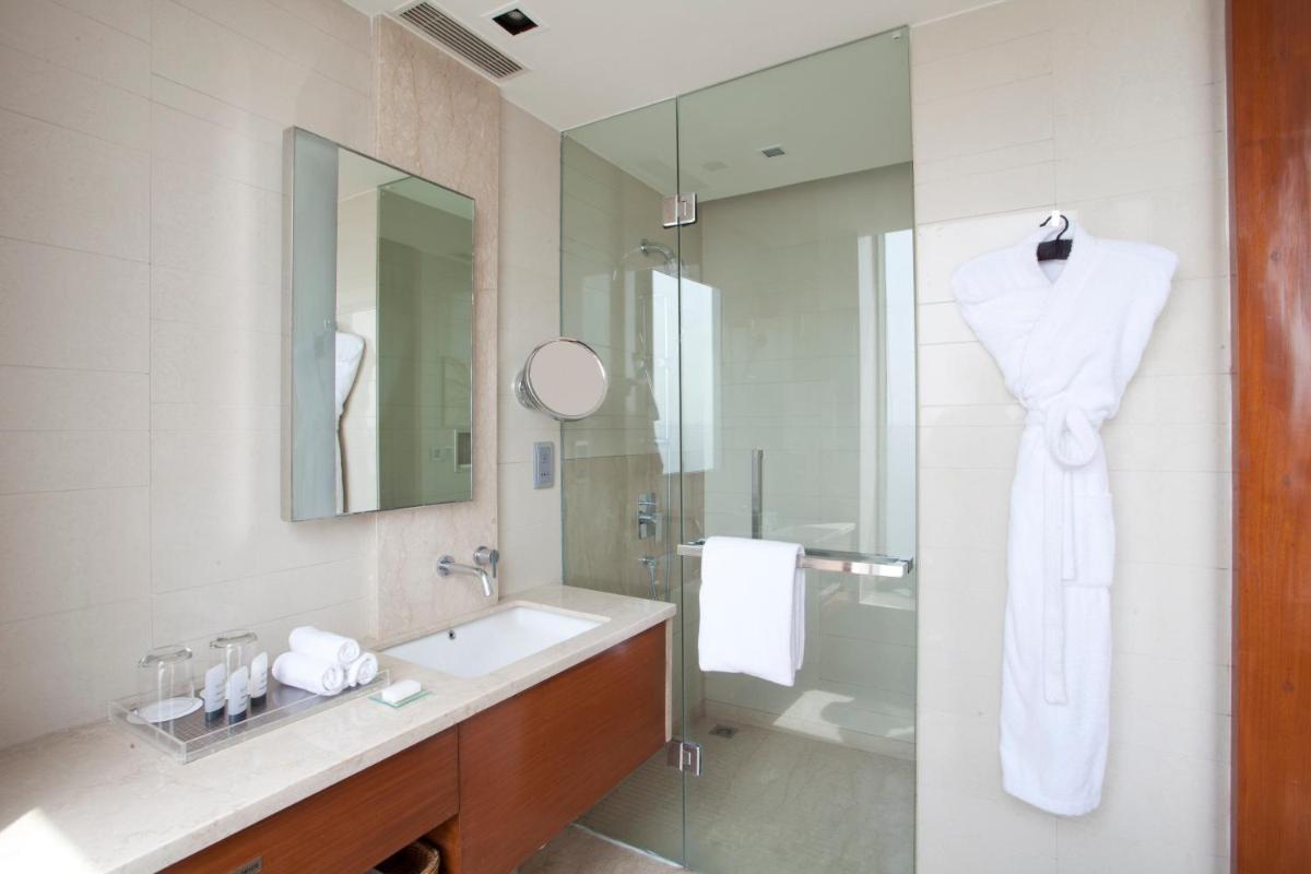 a bathroom with a sink and a mirror at Hyatt Regency Amritsar Hotel & Spa in Amritsar