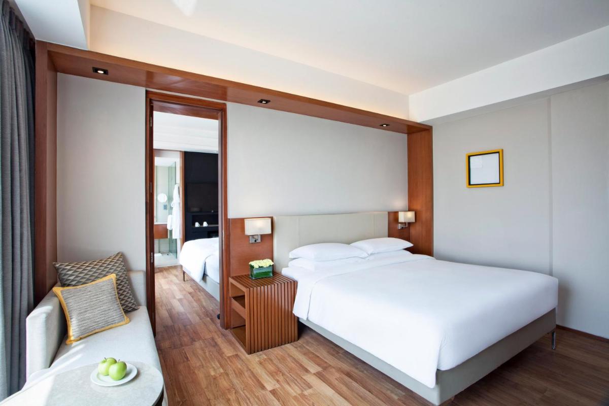 a hotel room with two beds and a chair at Hyatt Regency Amritsar Hotel & Spa in Amritsar