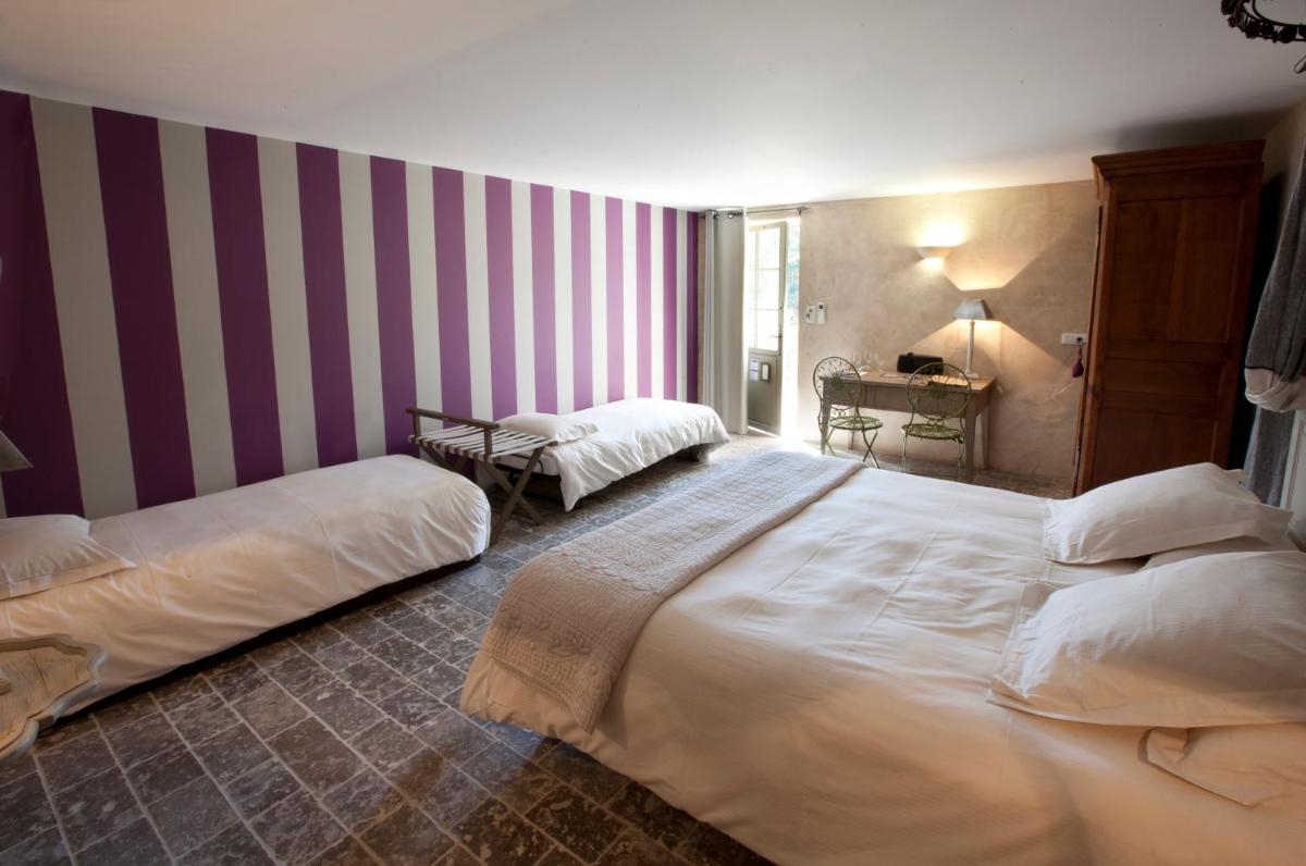 Un ou plusieurs lits dans un hébergement de l'établissement Hôtel-Spa Le Saint Cirq