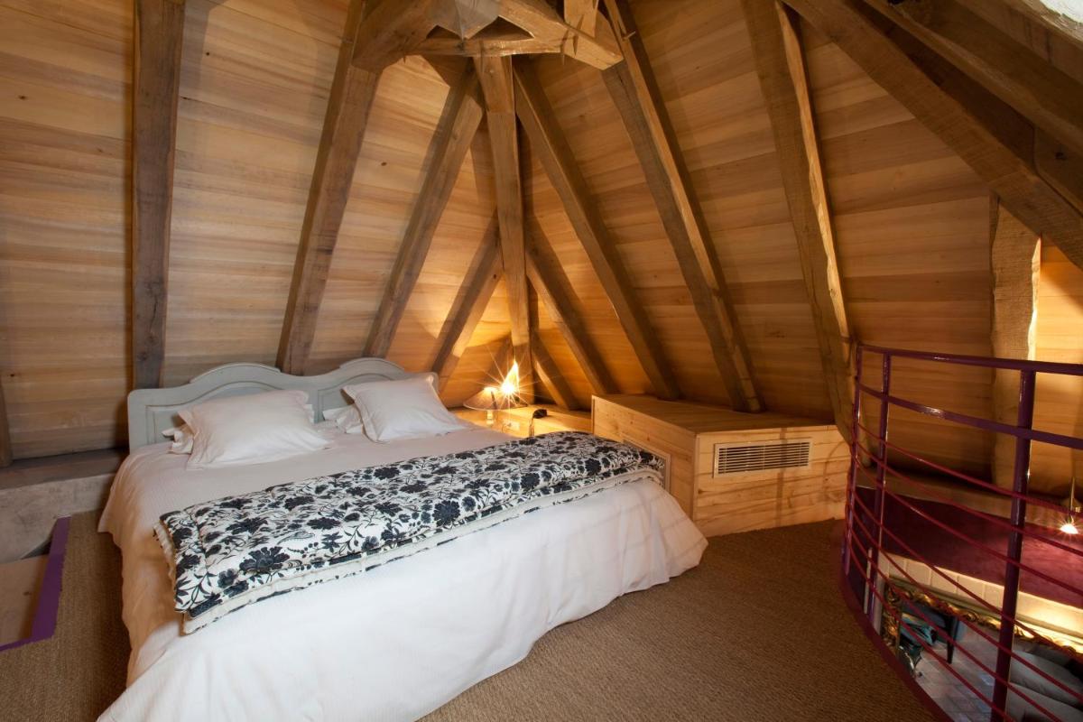 Un ou plusieurs lits dans un hébergement de l'établissement Hôtel-Spa Le Saint Cirq