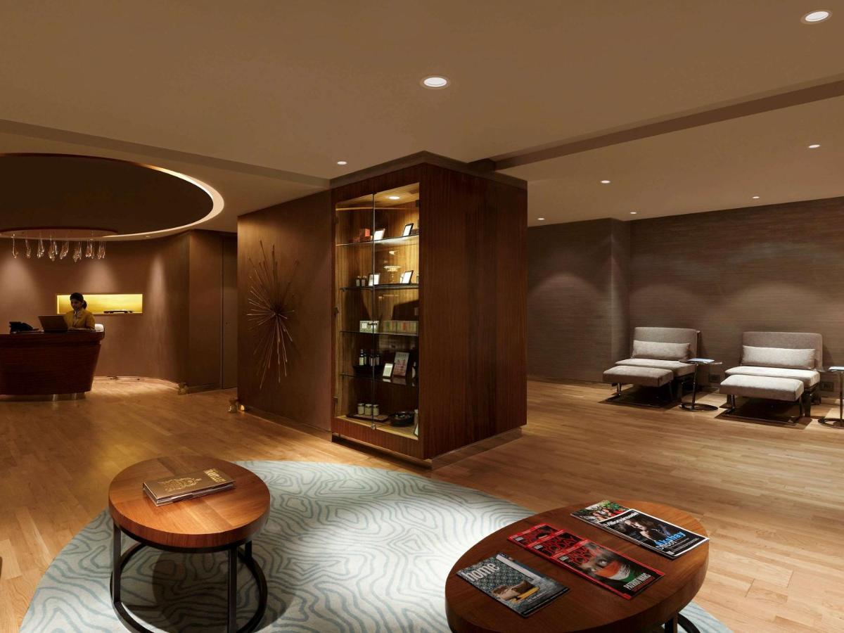 a living room with a table and chairs and a table sidx sidx sidx at Novotel New Delhi Aerocity in New Delhi