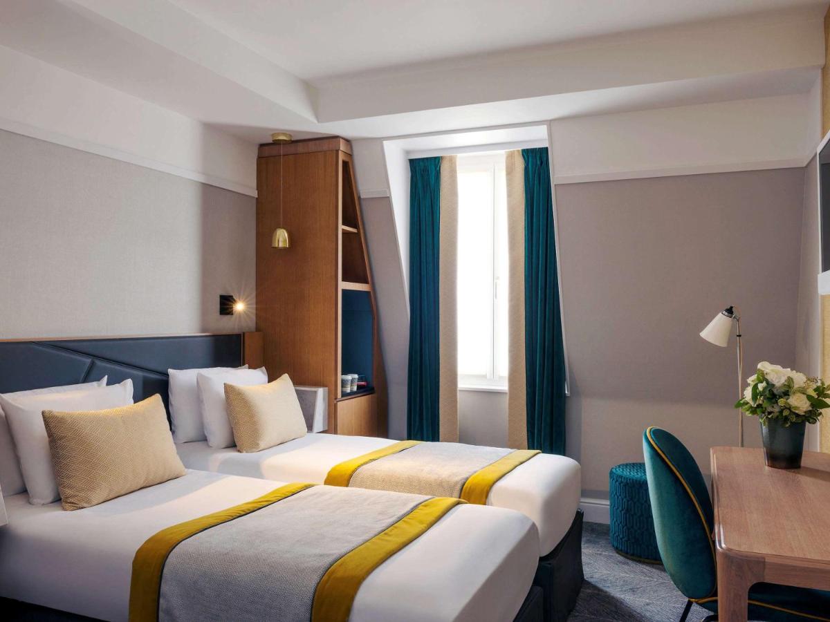Un ou plusieurs lits dans un hébergement de l'établissement Mercure Paris Opera Garnier Hôtel & Spa