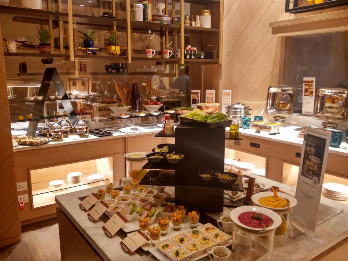 a buffet line with many different types of food at Welcomhotel by ITC Hotels, RaceCourse, Coimbatore in Coimbatore