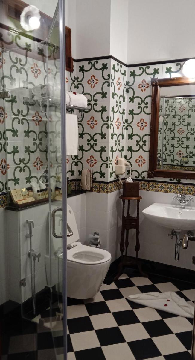a bathroom with a toilet and a sink at Forte Kochi in Cochin
