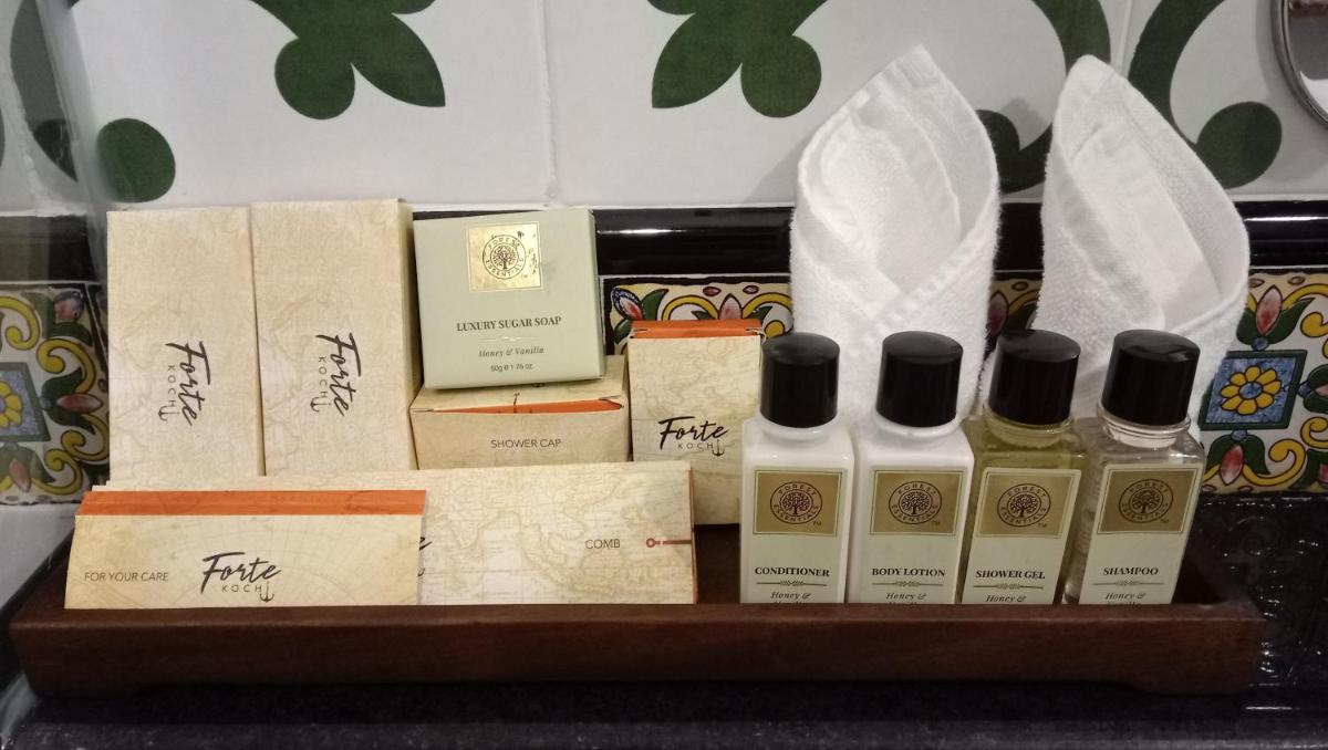 a shelf with a bunch of bottles of perfume at Forte Kochi in Cochin