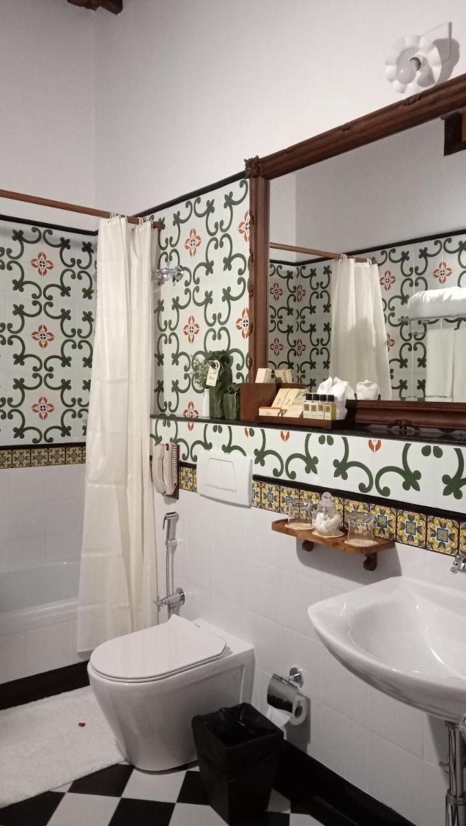 a bathroom with a toilet and a sink at Forte Kochi in Cochin