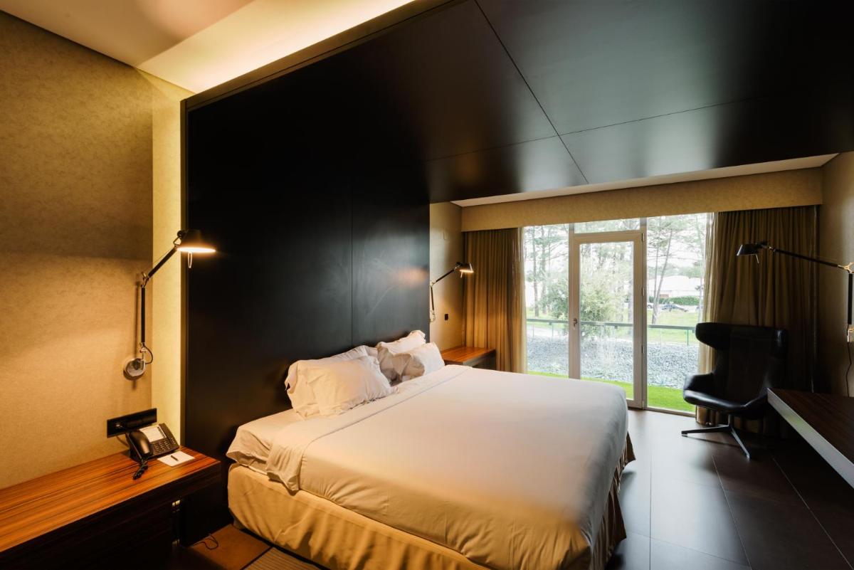 Uma cama ou camas num quarto em Evidencia Belverde Hotel