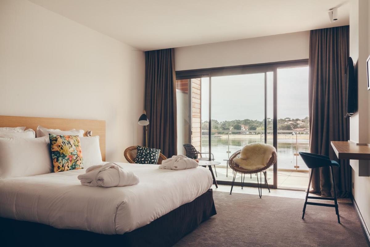 Un ou plusieurs lits dans un hébergement de l'établissement Hôtel & Spa Villa Seren