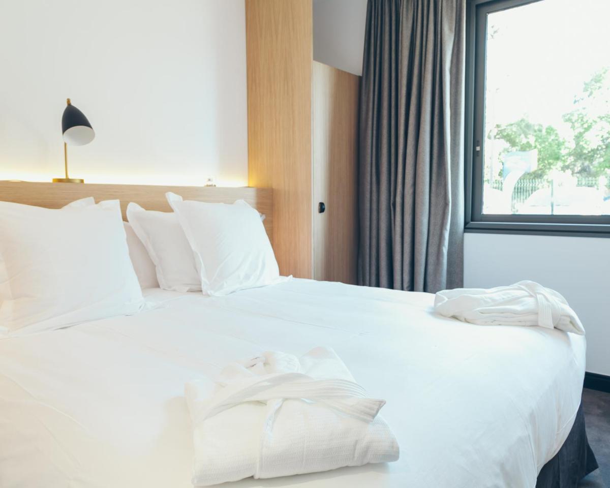 Un ou plusieurs lits dans un hébergement de l'établissement Hôtel & Spa Villa Seren