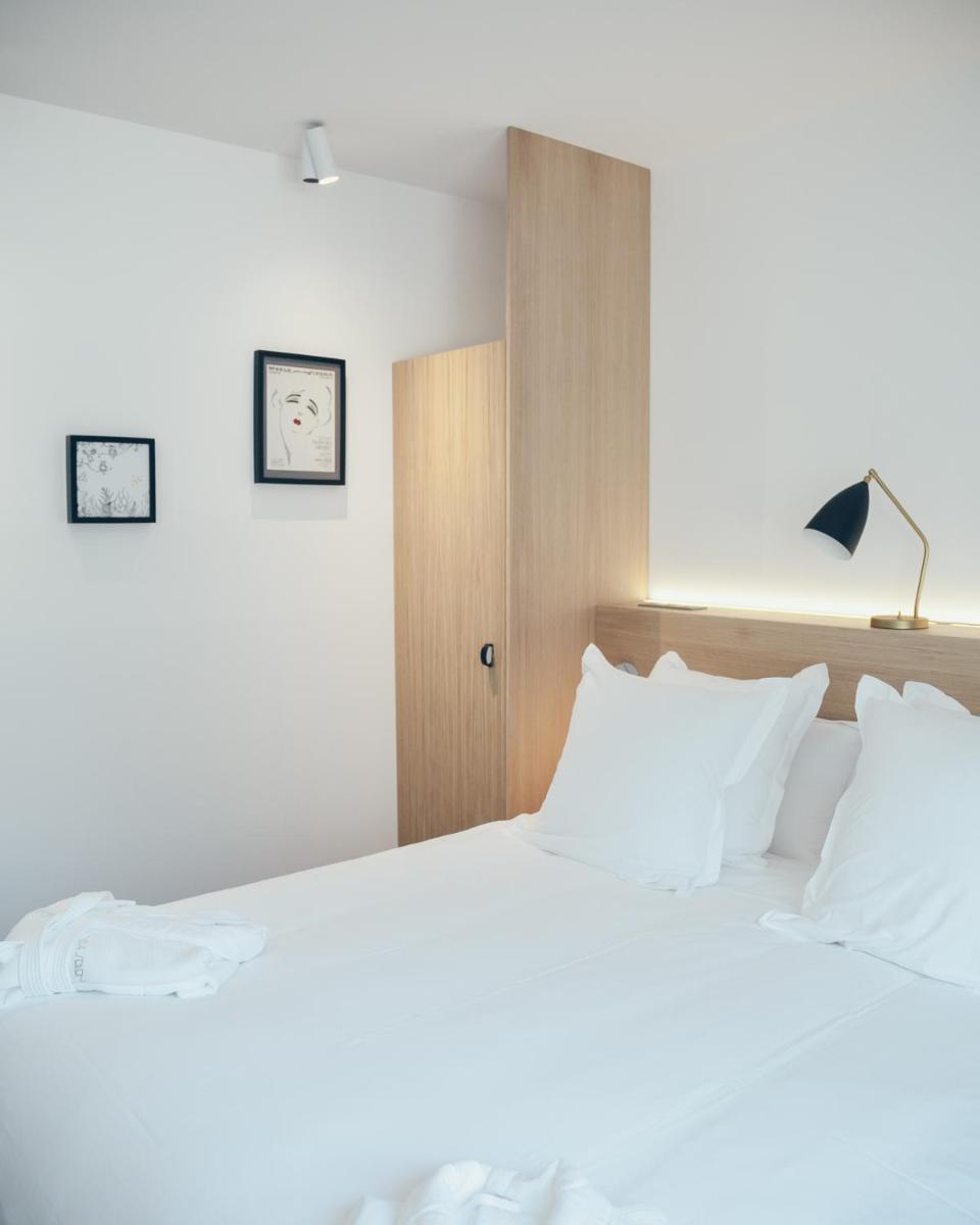 Un ou plusieurs lits dans un hébergement de l'établissement Hôtel & Spa Villa Seren