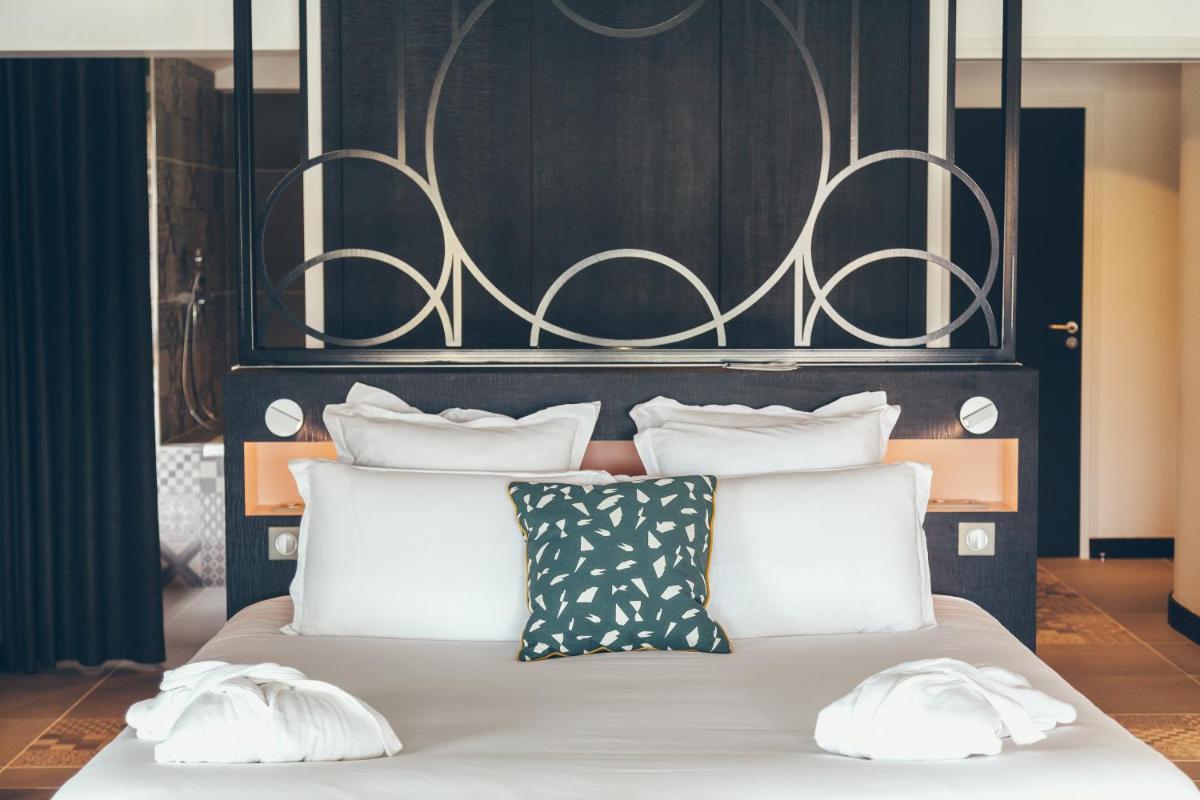 Un ou plusieurs lits dans un hébergement de l'établissement Hôtel & Spa Villa Seren