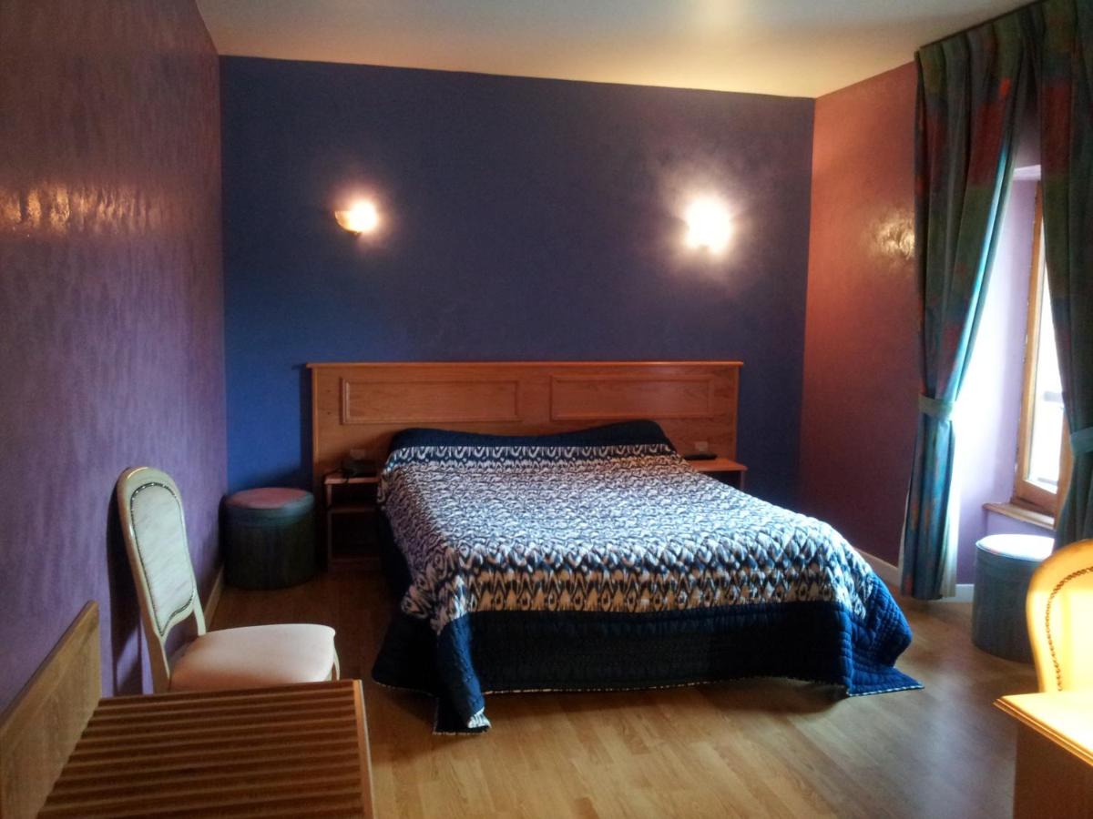 Un ou plusieurs lits dans un hébergement de l'établissement Maison Legate "Hôtel Le Baudiere & Spa"