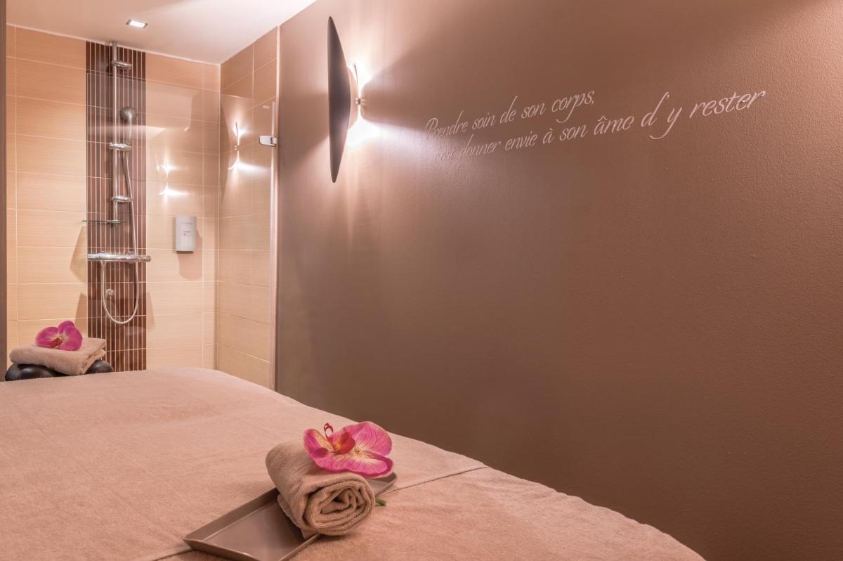 Un ou plusieurs lits dans un hébergement de l'établissement Résidence Hôtelière Natureva & Spa