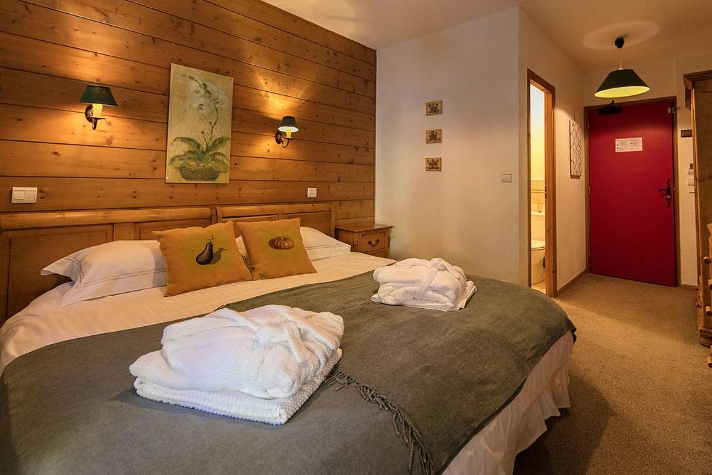 Un ou plusieurs lits dans un hébergement de l'établissement Hôtel et Chalet Au Coin Du Feu Chilly Powder
