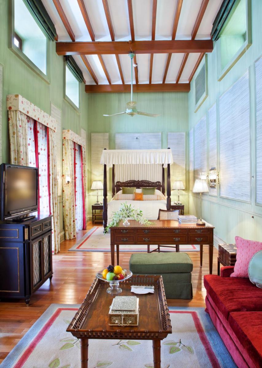 a living room with a bed and a table at Taj Falaknuma Palace in Hyderabad