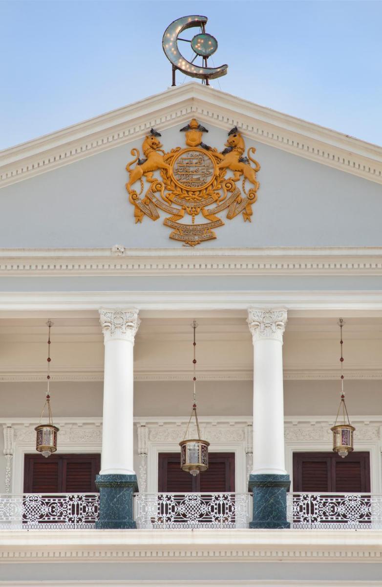 a clock on top of a building with columns at Taj Falaknuma Palace in Hyderabad