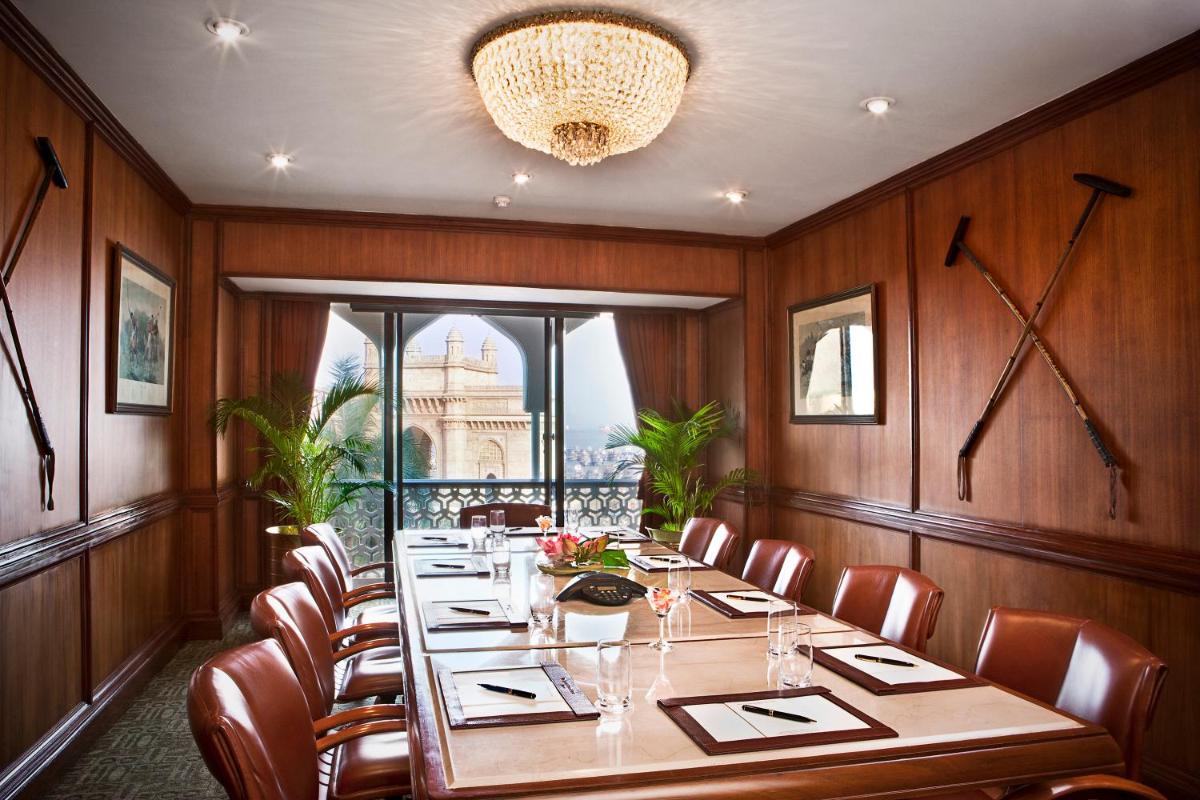 a dining room with a long table and chairs at The Taj Mahal Tower, Mumbai in Mumbai a dining room with a long table and chairs at The Taj Mahal Tower, Mumbai in Mumbai