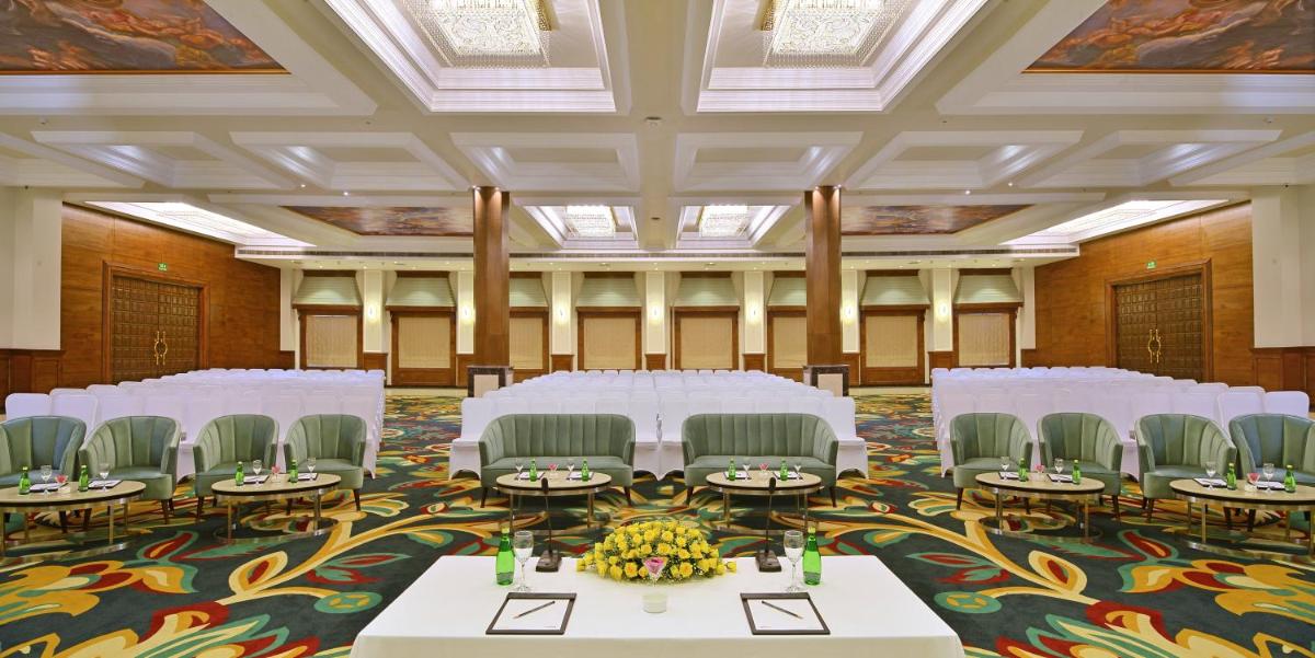 a banquet hall with white tables and chairs at Radisson Chandigarh Zirakpur in Chandīgarh