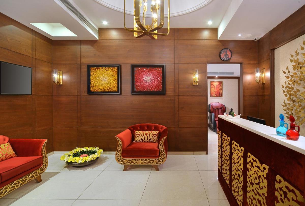 a lobby with two red chairs and a bar at Radisson Chandigarh Zirakpur in Chandīgarh