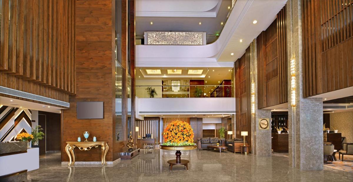 a lobby of a hotel with a flower centerpiece in the middle at Radisson Chandigarh Zirakpur in Chandīgarh