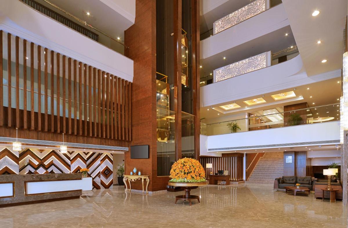 a lobby of a hotel with a large lobby at Radisson Chandigarh Zirakpur in Chandīgarh