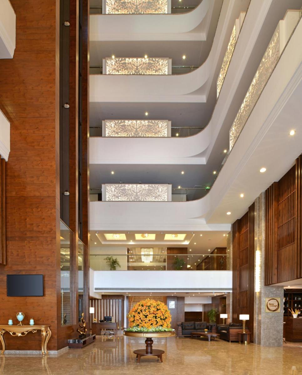 a lobby of a hotel with a large ceiling at Radisson Chandigarh Zirakpur in Chandīgarh