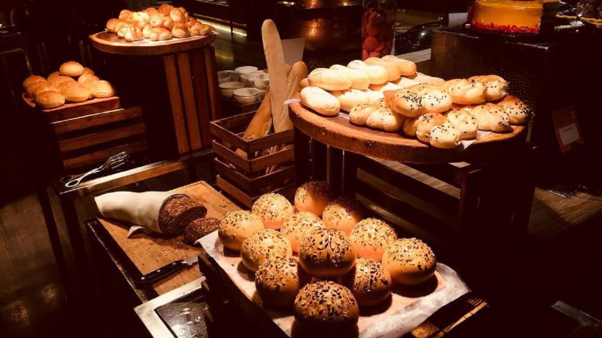 a display of different types of donuts in a bakery at Novotel Ahmedabad in Ahmedabad