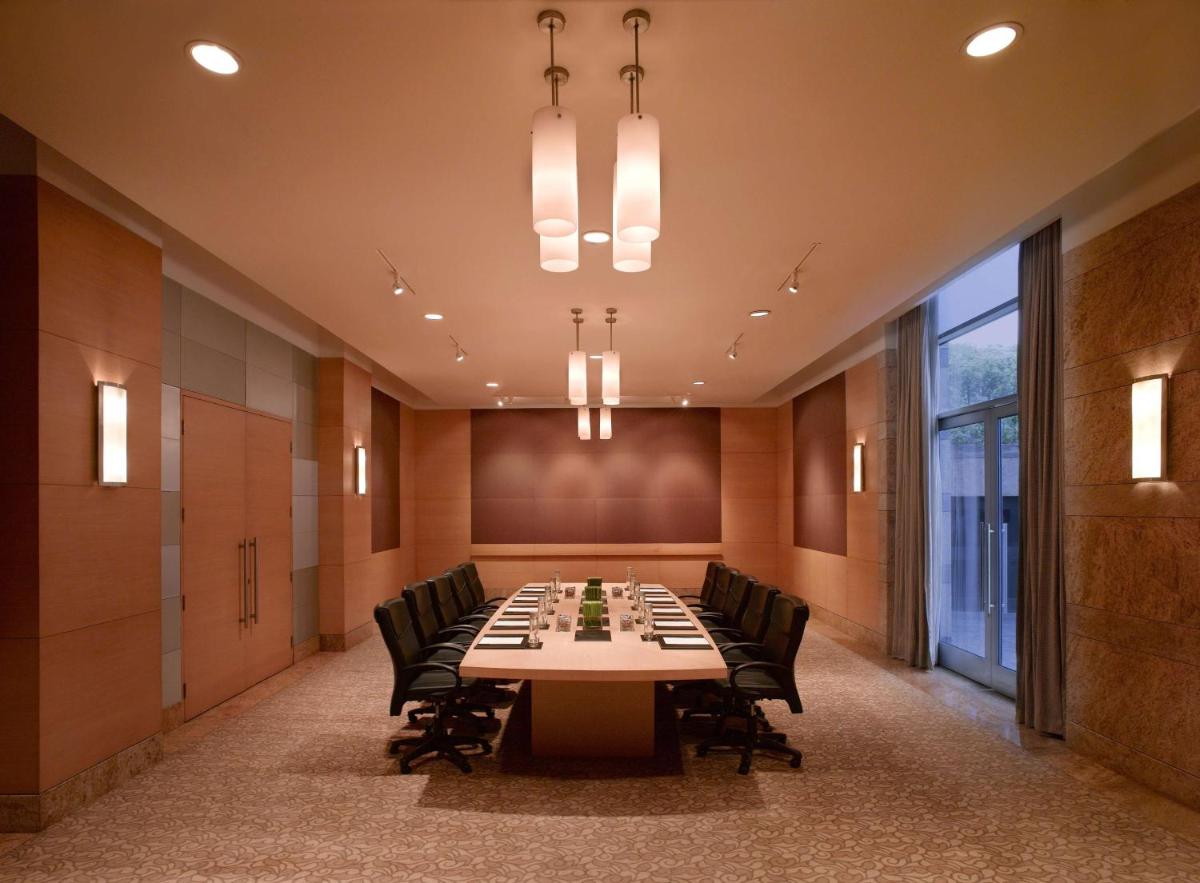 a large conference room with a long table and chairs at Grand Hyatt Mumbai Hotel and Residences in Mumbai