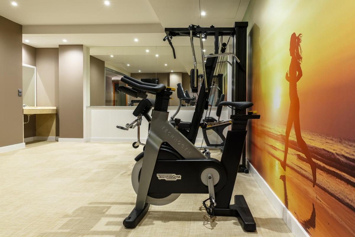 un gimnasio con cintas de correr en una habitación en BQ Andalucia Beach Hotel, en Torre del Mar