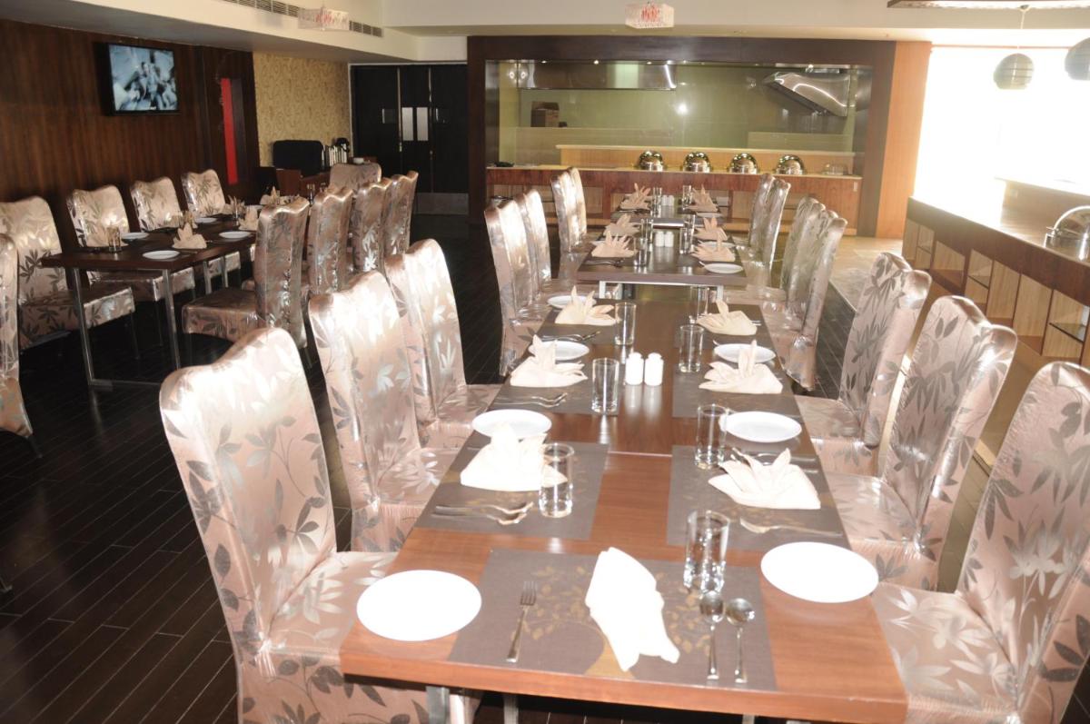 a long dining room with a long table and chairs at Fortune Select Grand Ridge, Tirupati - Member ITC Hotels' Group in Tirupati