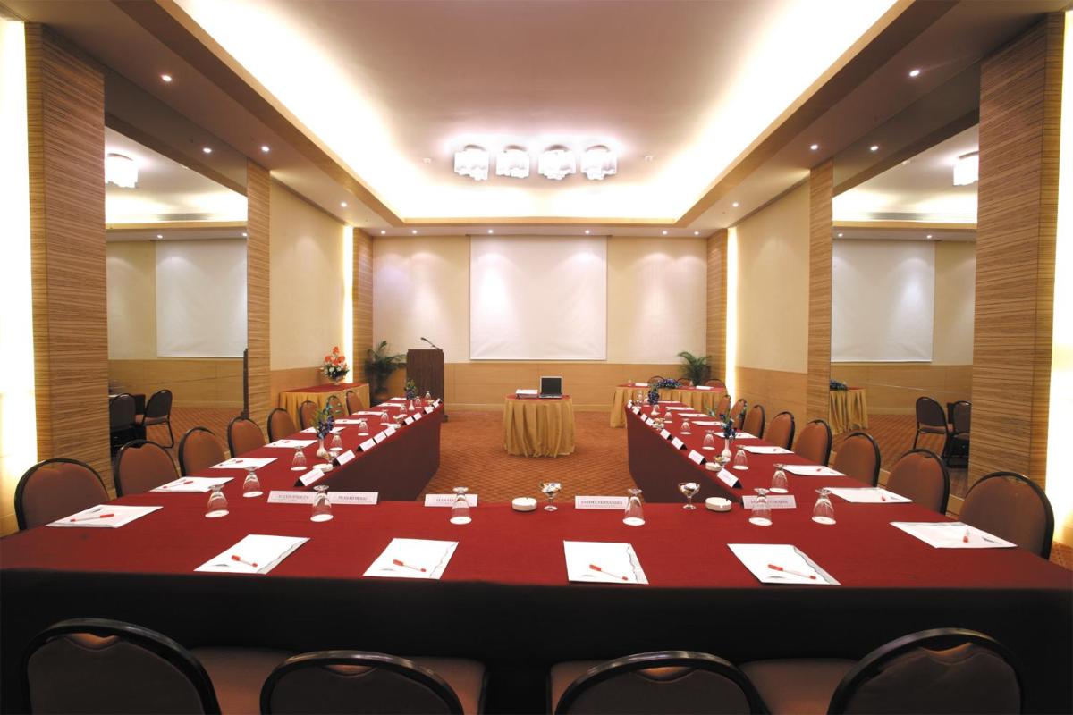 a large room with tables and chairs in it at The Retreat Hotel & Convention Centre in Mumbai