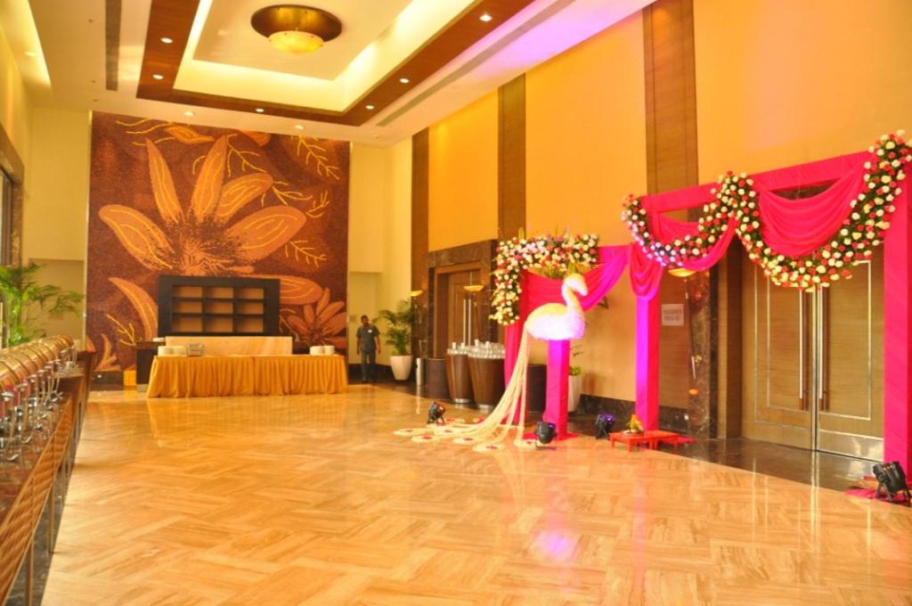 a room with a dance floor with a pink stage at The Retreat Hotel & Convention Centre in Mumbai