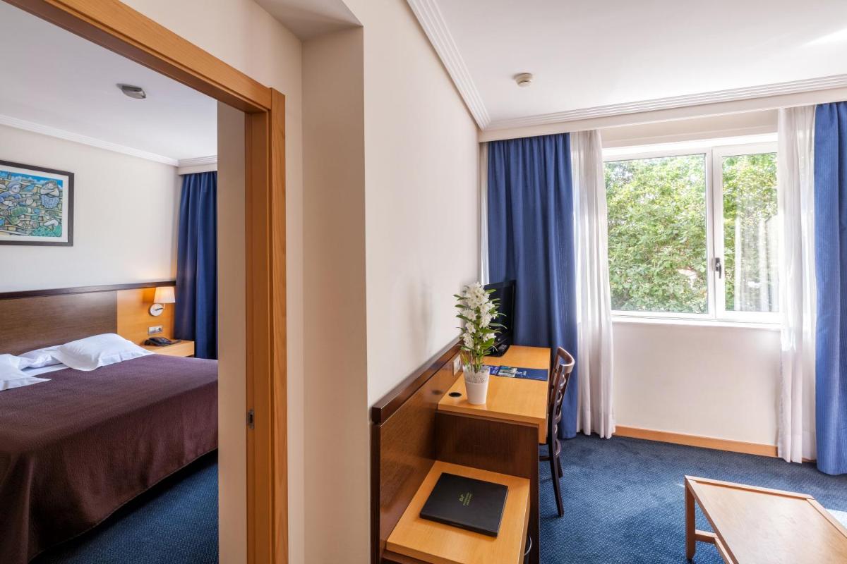 Cama o camas de una habitación en Hotel Balneario de Compostela