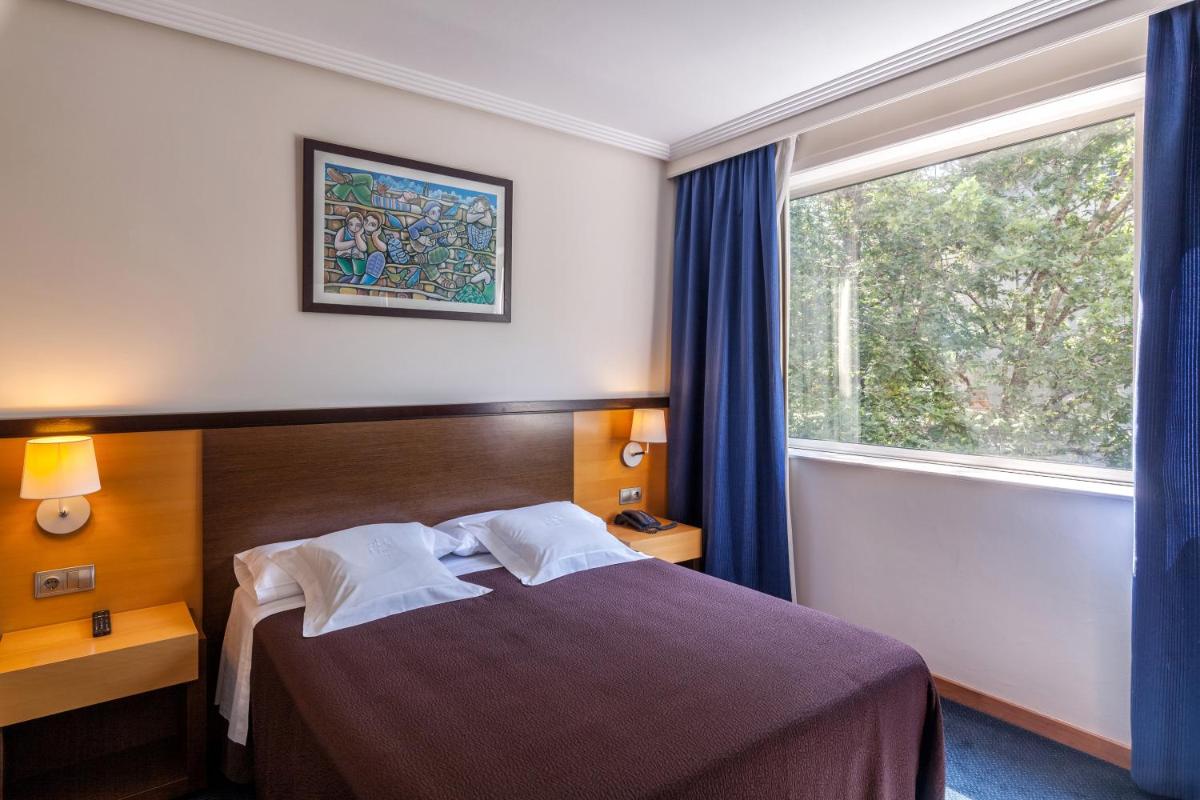 Cama o camas de una habitación en Hotel Balneario de Compostela