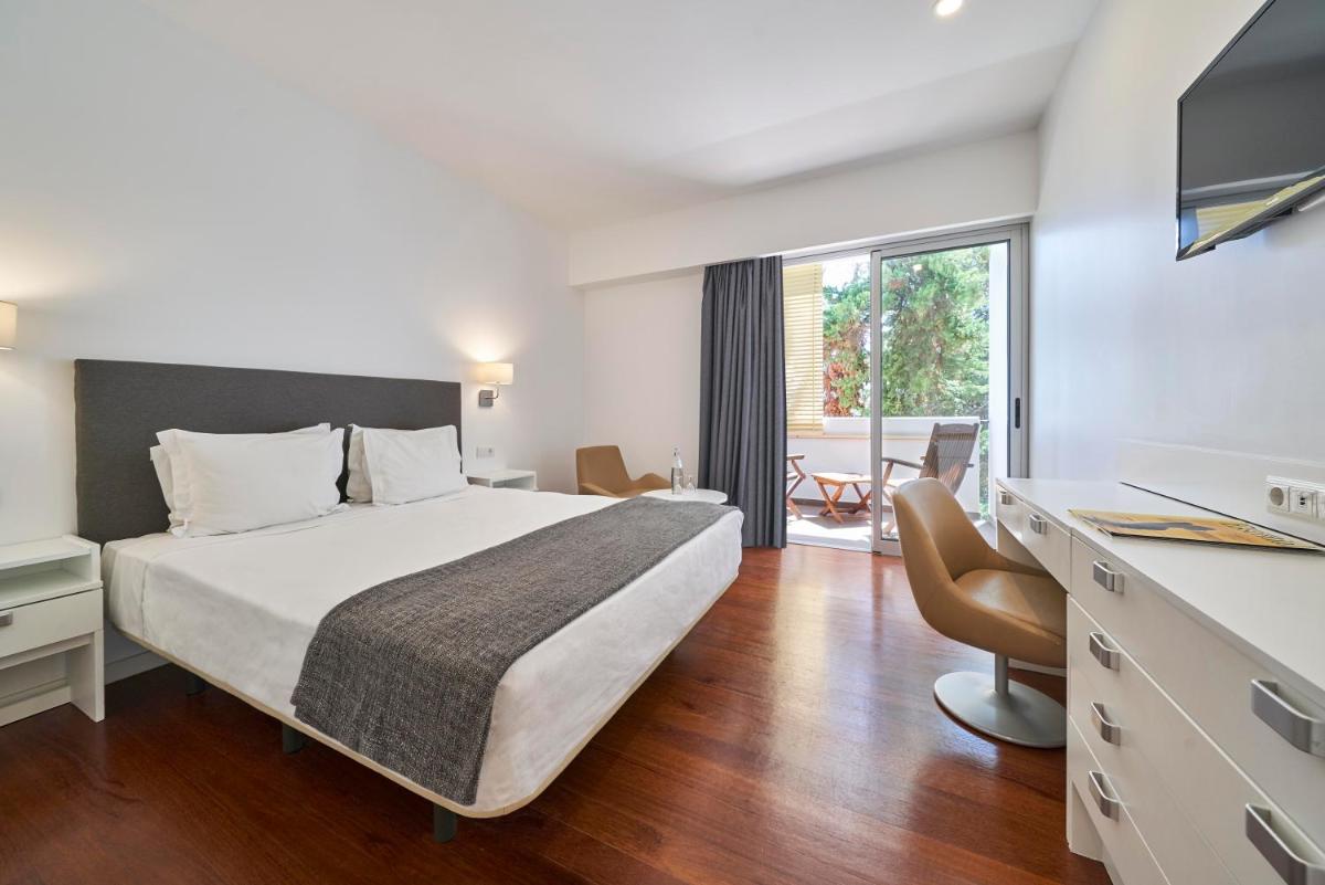 Uma cama ou camas num quarto em Hotel Porto Santo & Spa
