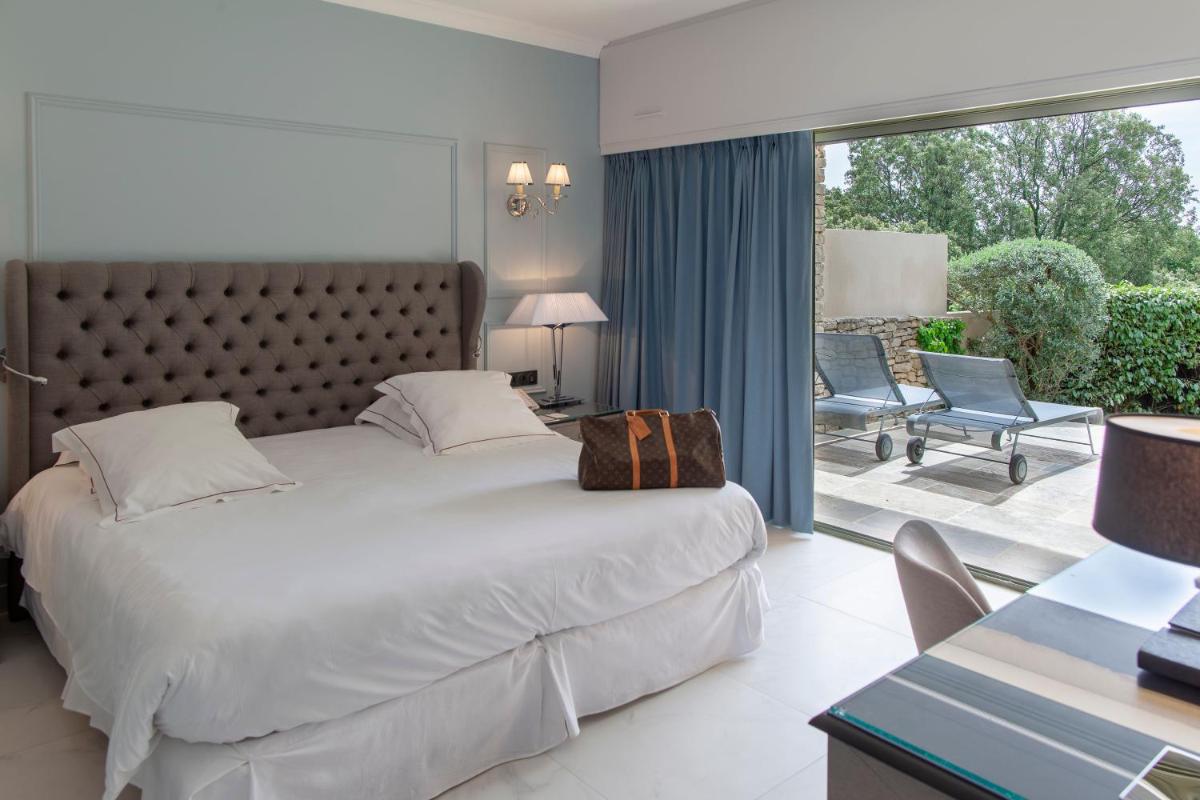 Un ou plusieurs lits dans un hébergement de l'établissement Hotel Les Bories & Spa