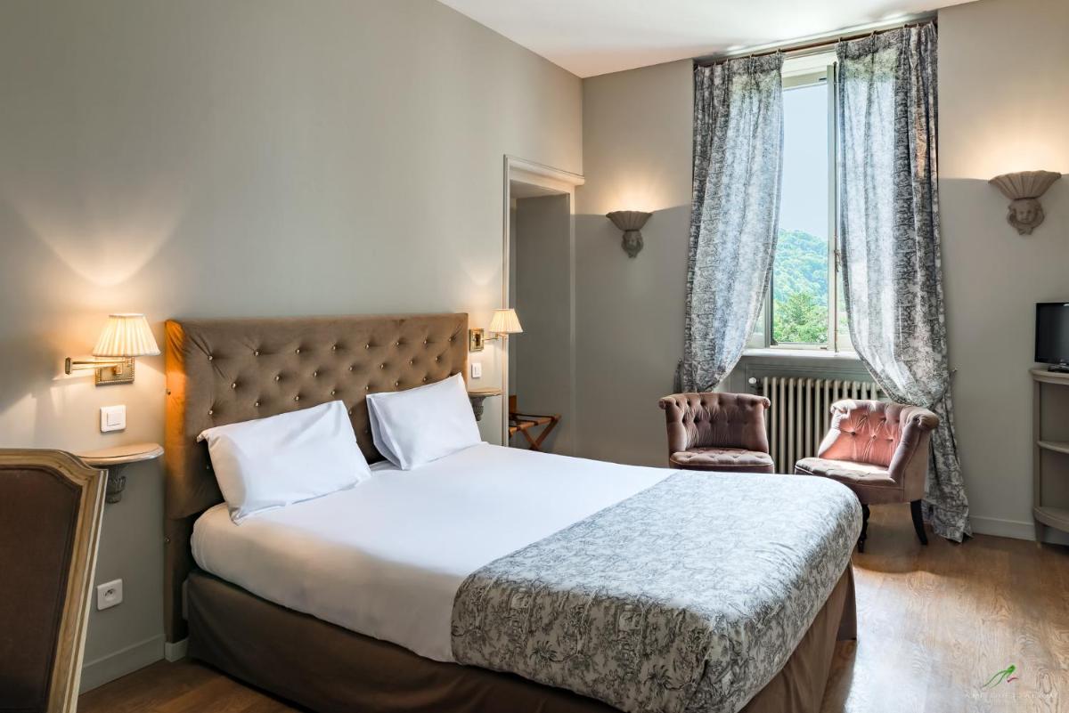 Un ou plusieurs lits dans un hébergement de l'établissement Hôtel Restaurant Spa Le Sauvage