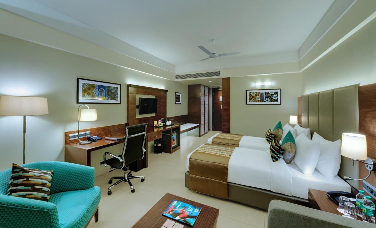 a hotel room with a bed and a desk at The Fern Kadamba Hotel And Spa in Old Goa