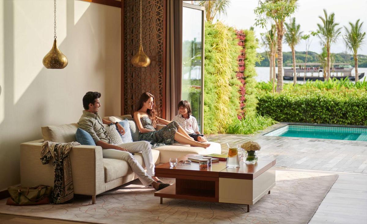 a group of people sitting on a couch in a living room at Grand Hyatt Kochi Bolgatty in Cochin