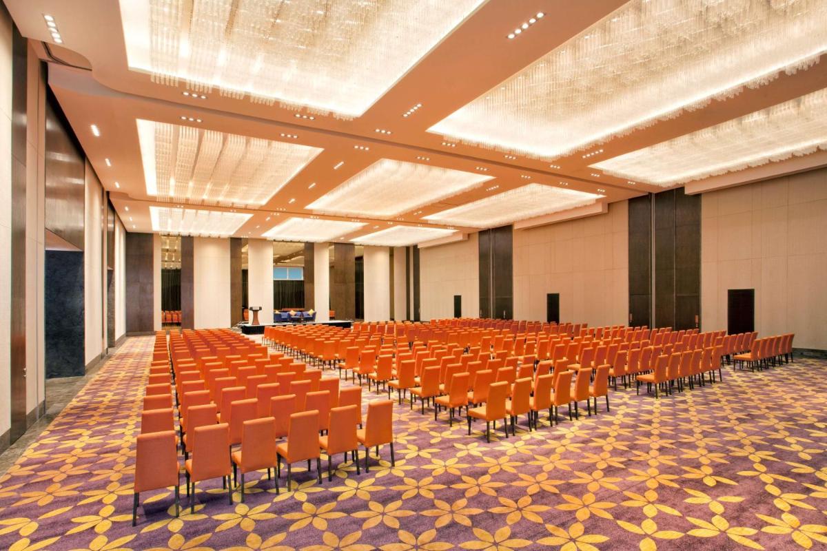 an empty hall with orange chairs in a building at Grand Hyatt Kochi Bolgatty in Cochin +44 photos