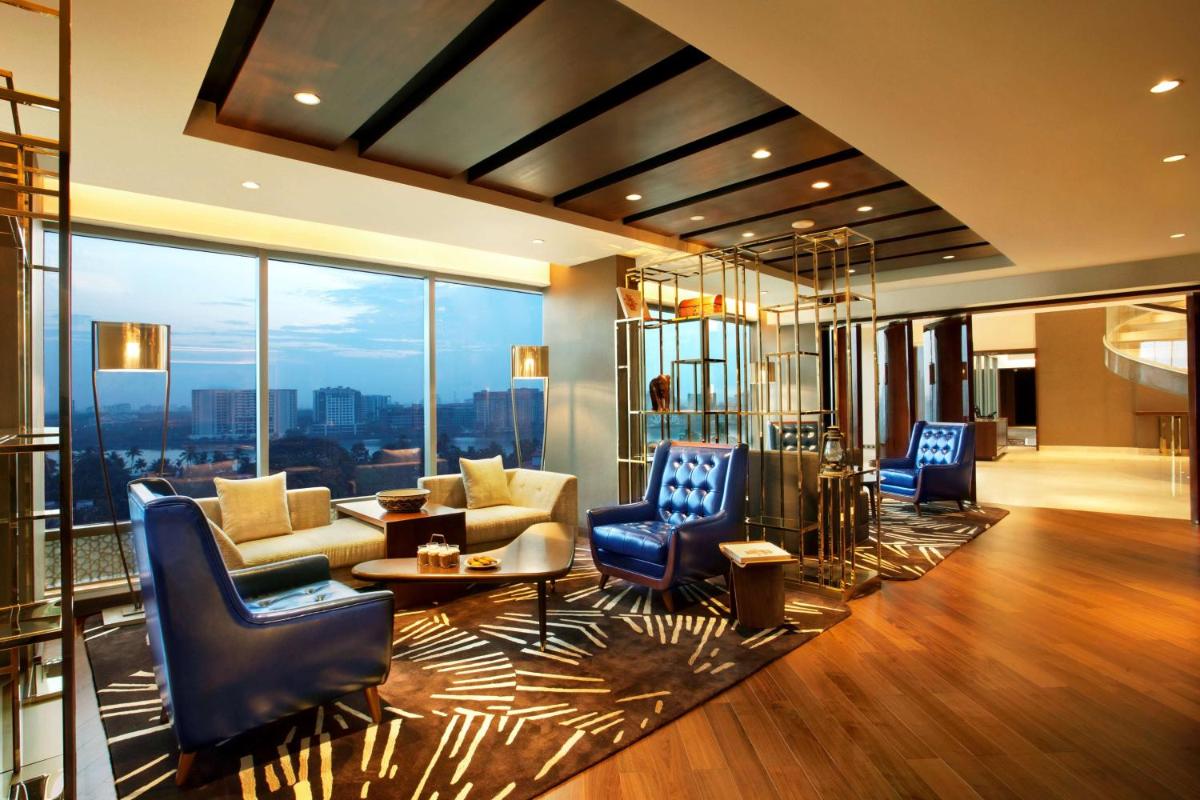 a living room with furniture and a view of the city at Grand Hyatt Kochi Bolgatty in Cochin