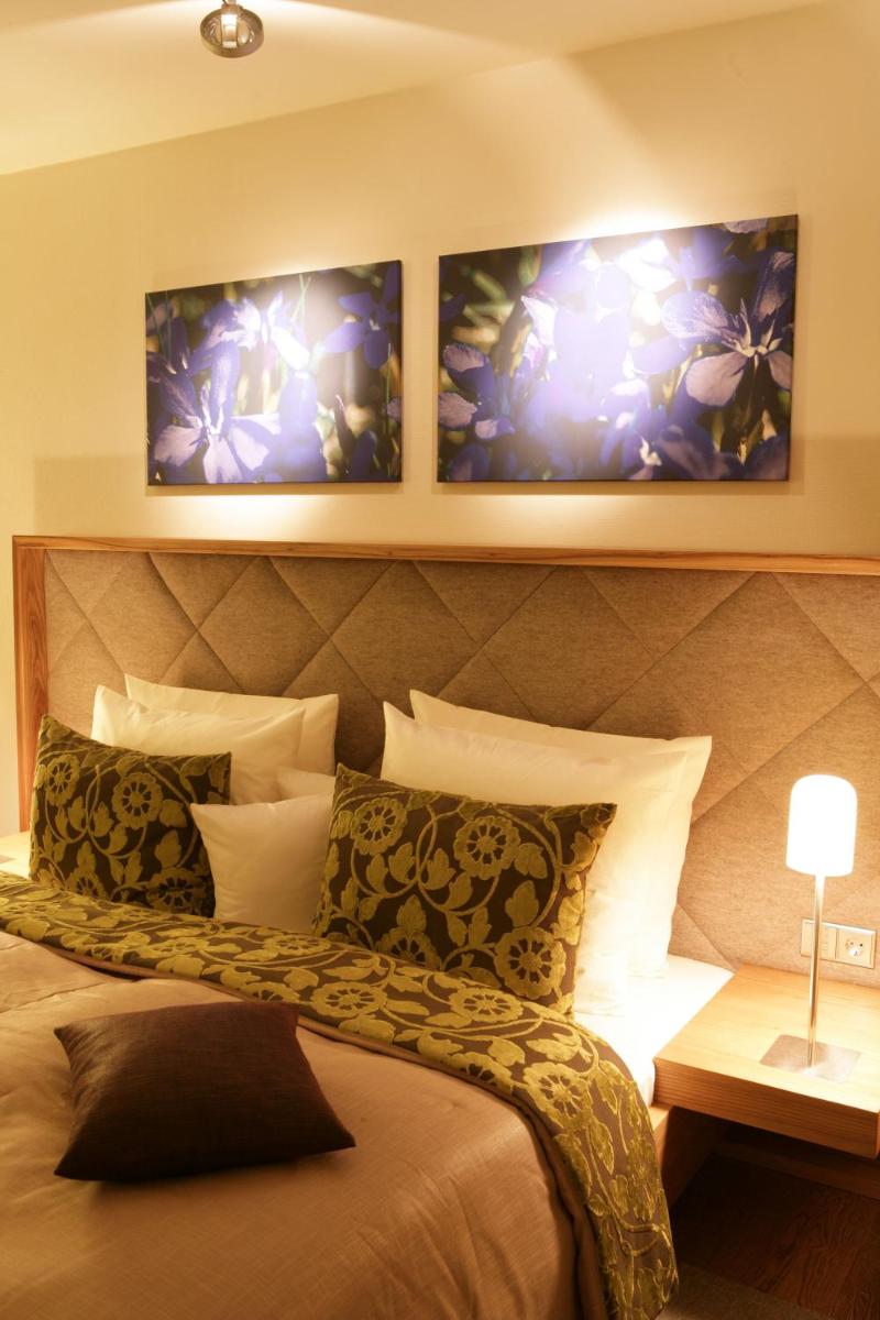 Ein Bett oder Betten in einem Zimmer der Unterkunft Hotel Maximilian