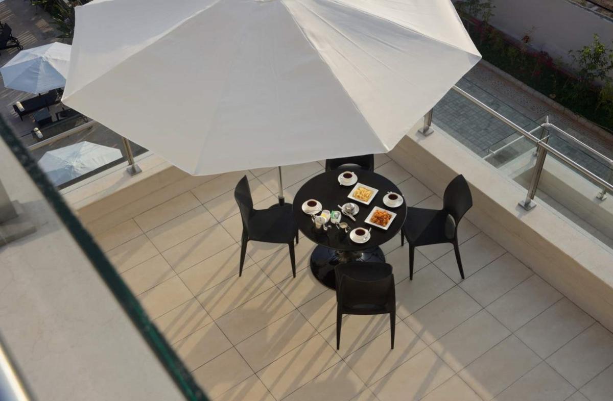 an overhead view of a table and chairs with an umbrella at Marasa Sarovar Premiere in Tirupati