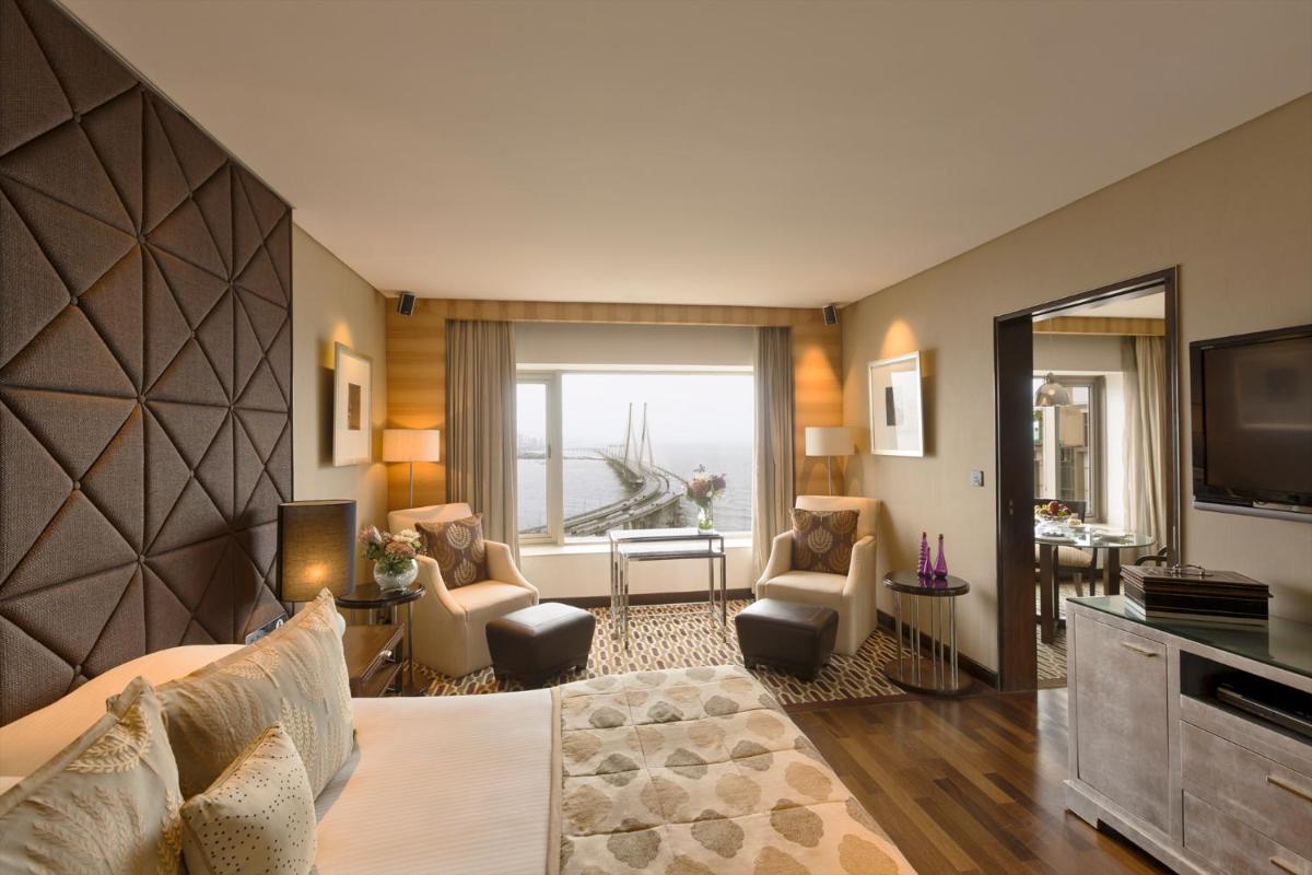 a hotel room with a bed and a television at Taj Lands End in Mumbai a hotel room with a bed and a television at Taj Lands End in Mumbai