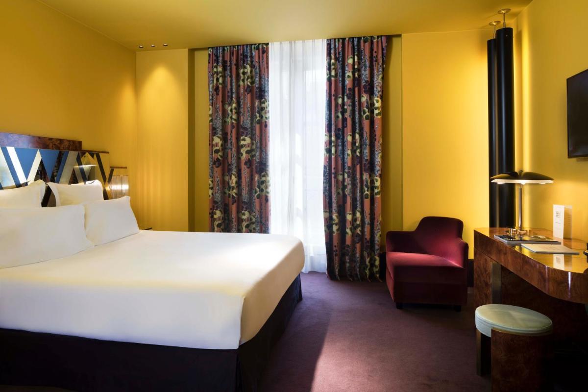 Un ou plusieurs lits dans un hébergement de l'établissement Hôtel Saint-Marc