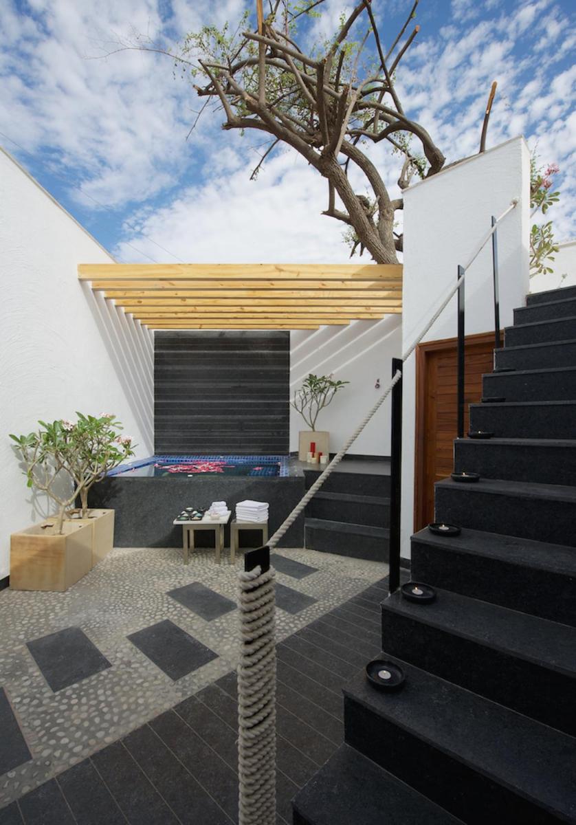 a modern house with a staircase and a tree at Hotel Lakend in Udaipur