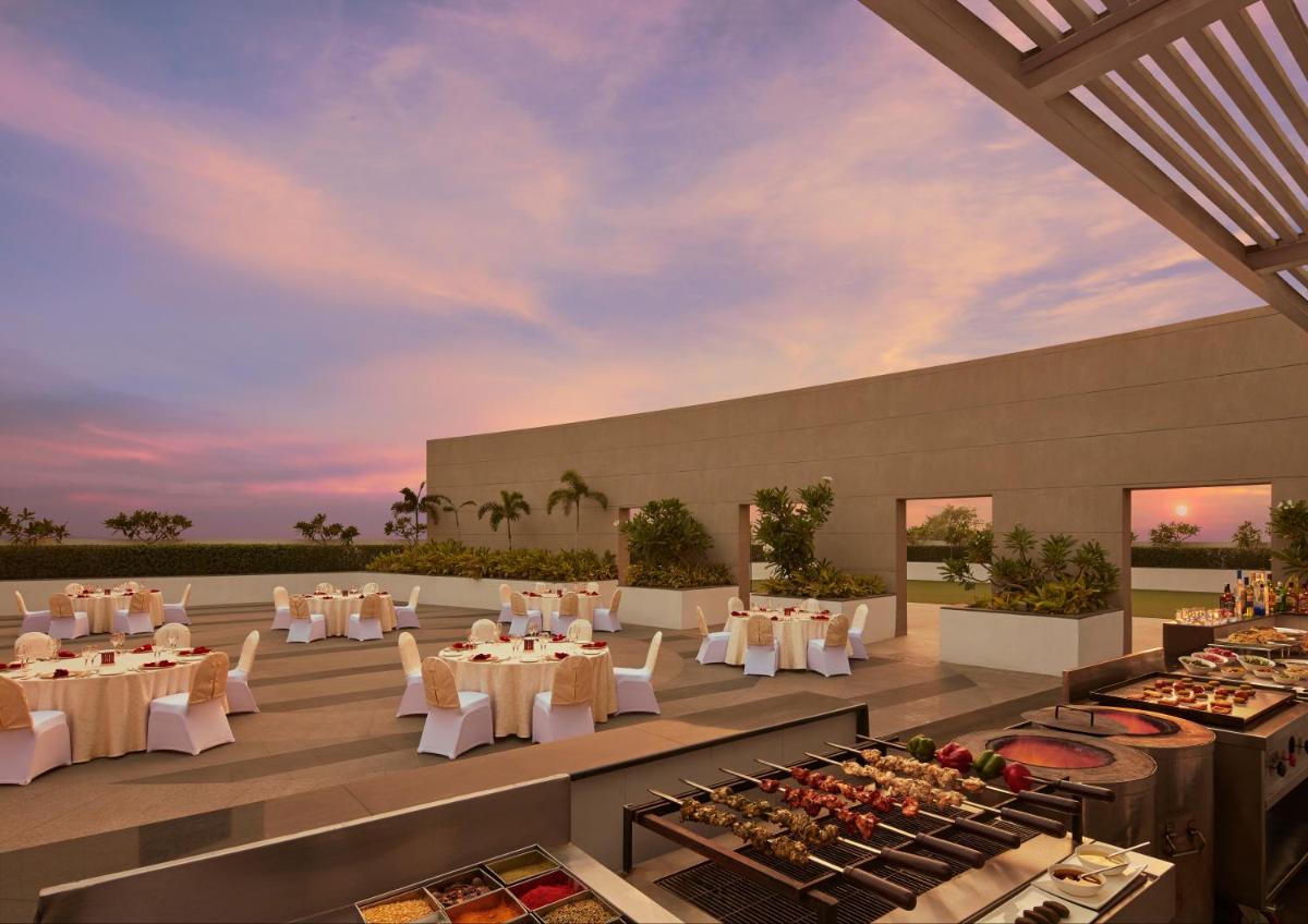 a rendering of a restaurant with tables and chairs at Taj Swarna, Amritsar in Amritsar