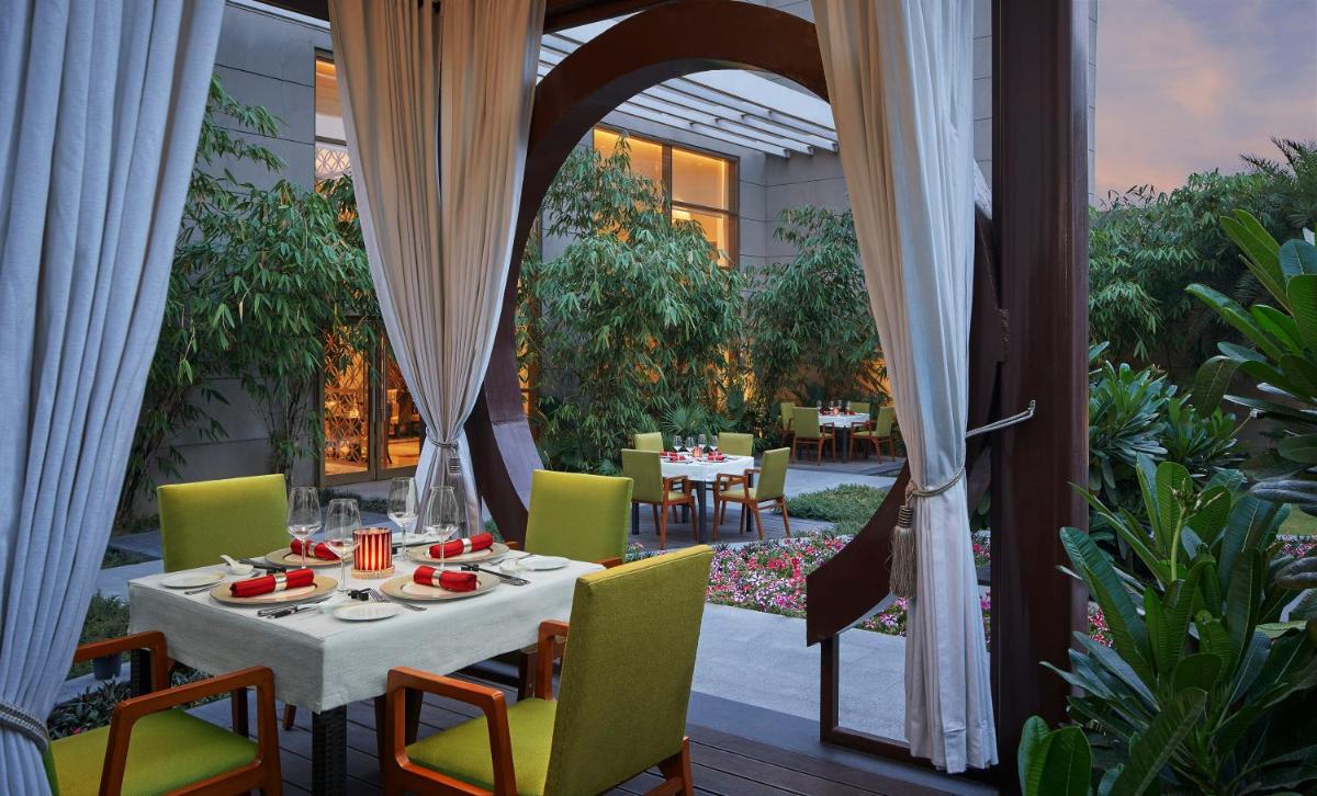 a patio with a table and chairs on a patio at Taj Swarna, Amritsar in Amritsar