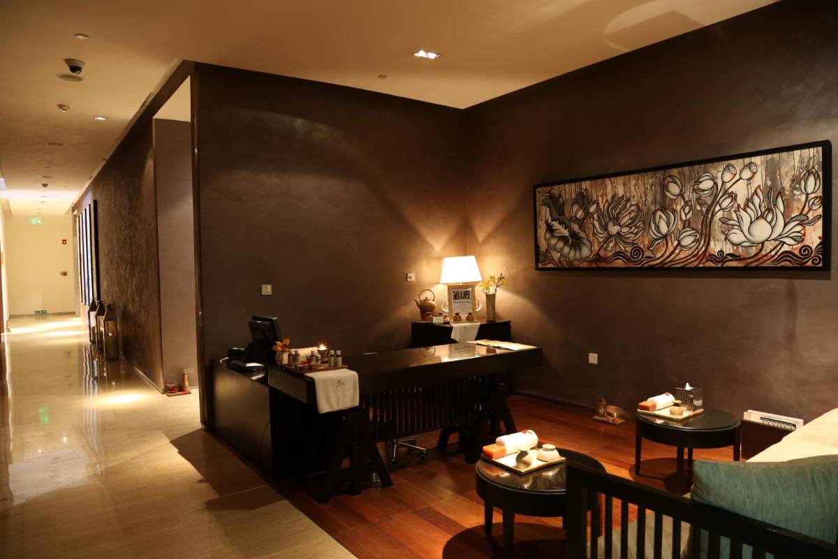 a room with a bar and some tables and chairs at Taj City Centre Gurugram in Gurgaon
